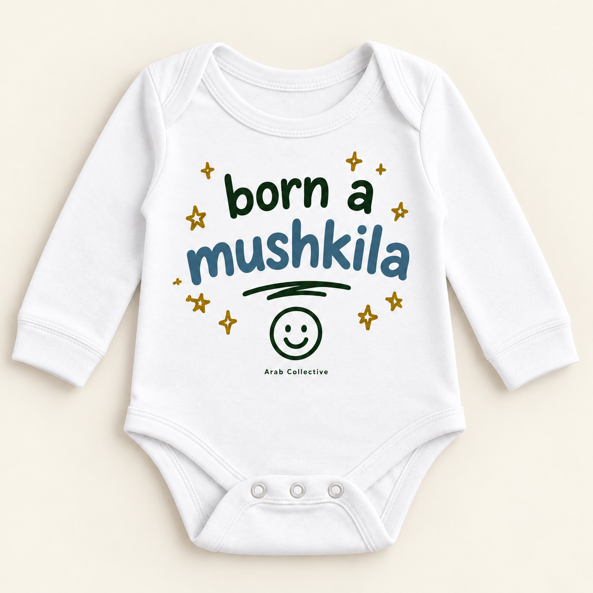"BORN A MUSHKILA" NEWBORN ONESIE LONG SLEEVE