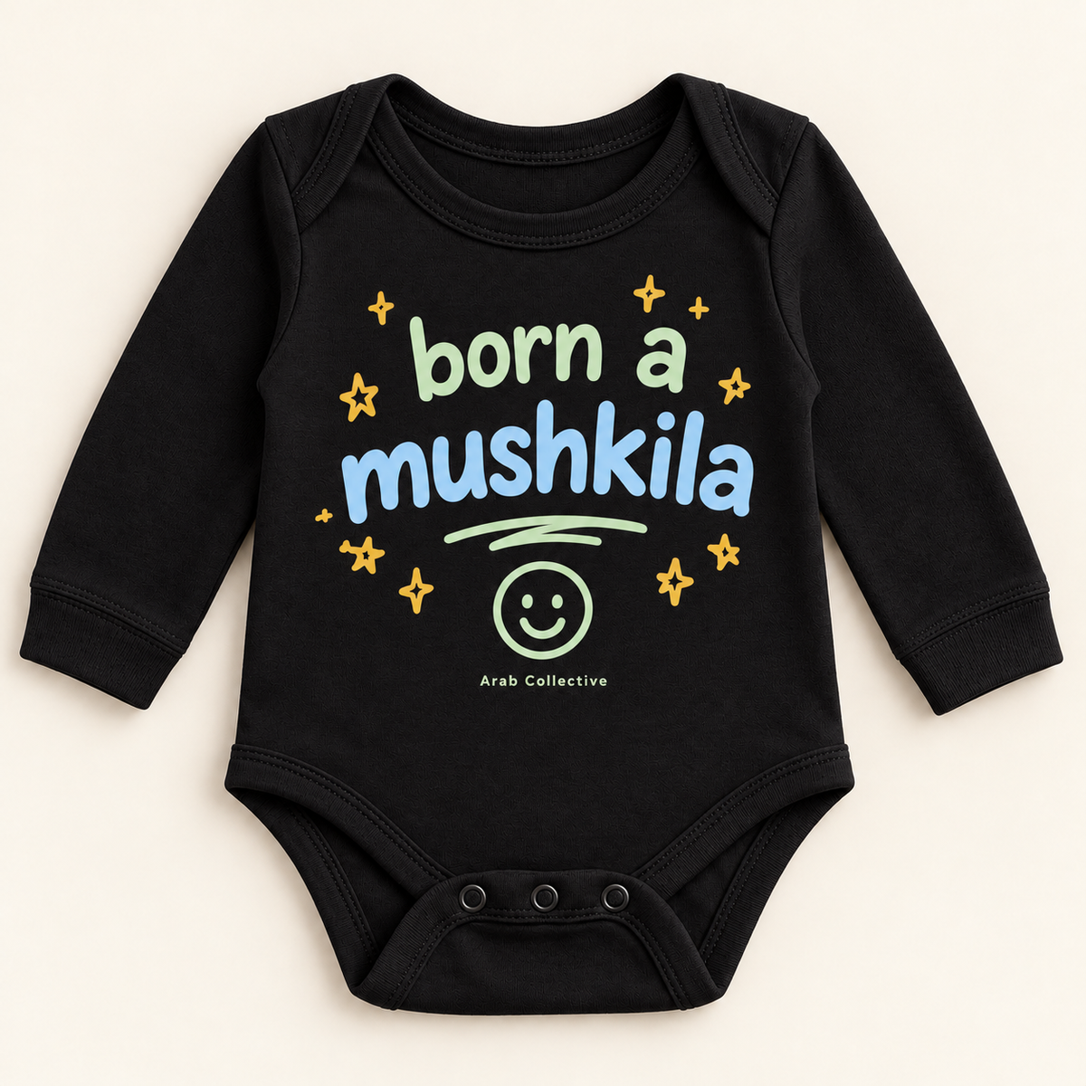 "BORN A MUSHKILA" NEWBORN ONESIE LONG SLEEVE