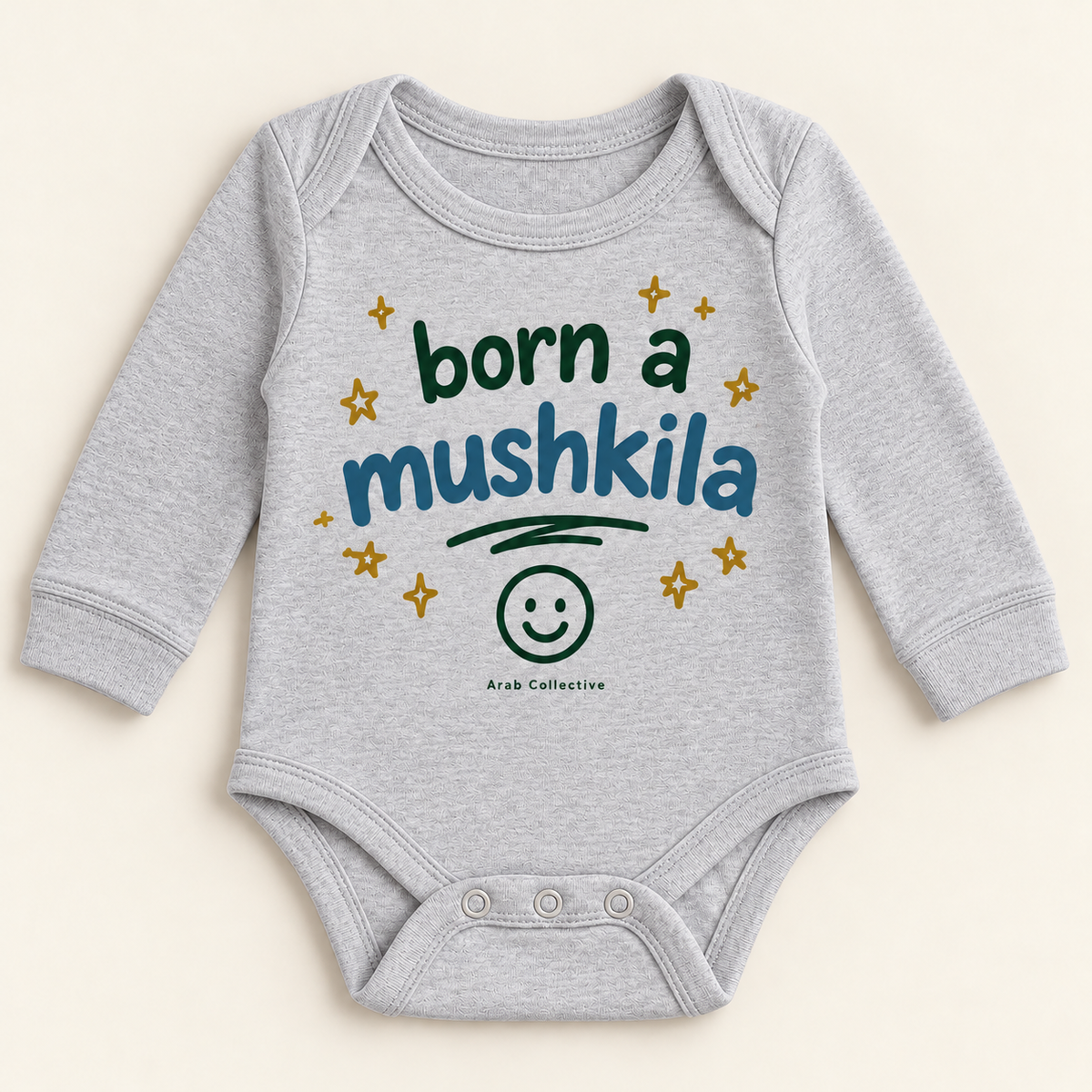 "BORN A MUSHKILA" NEWBORN ONESIE LONG SLEEVE